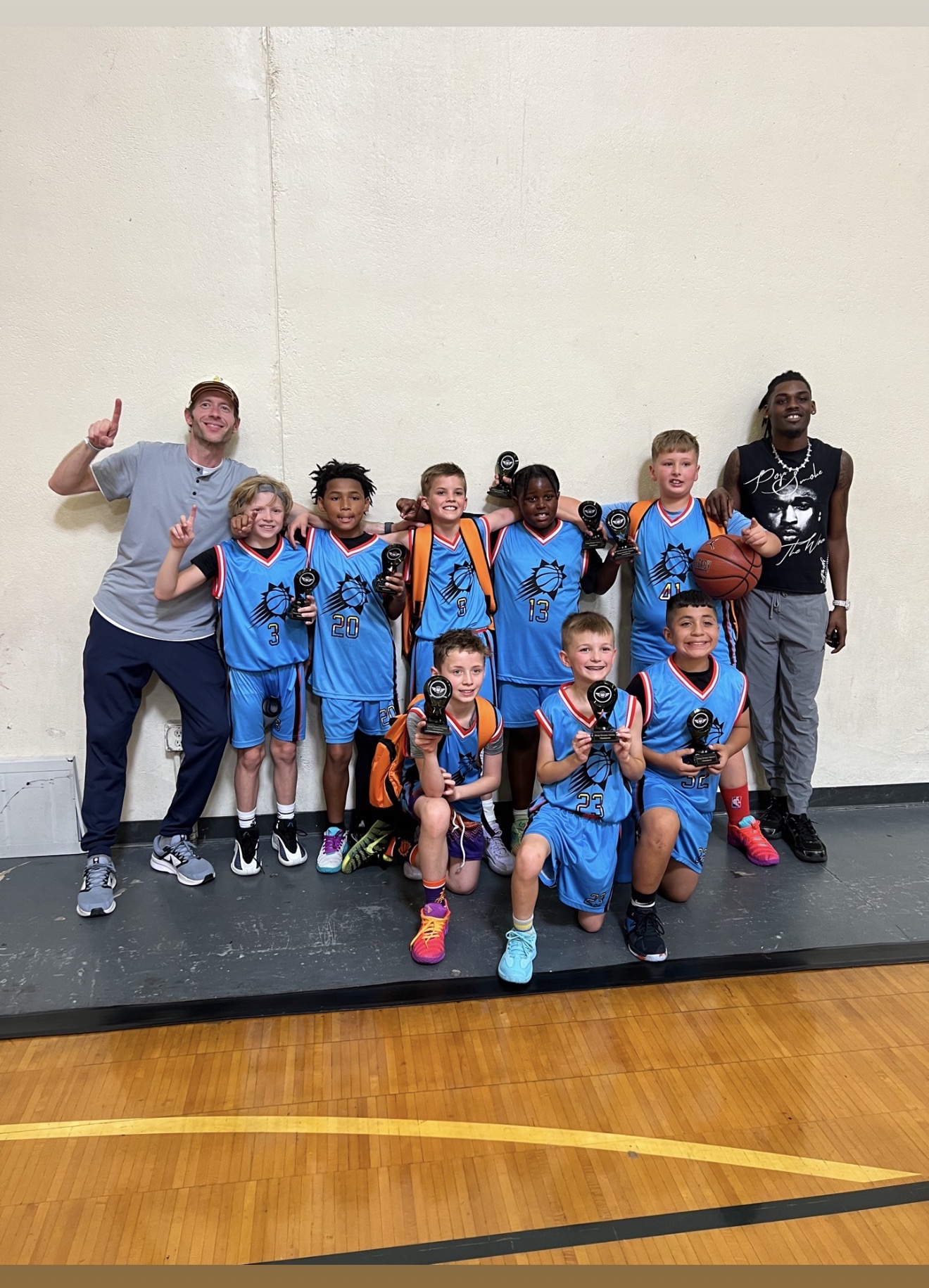 BEA Suns 3rd and 4th grade team celebrating with their coaches and trophies after winning in Colorado Springs