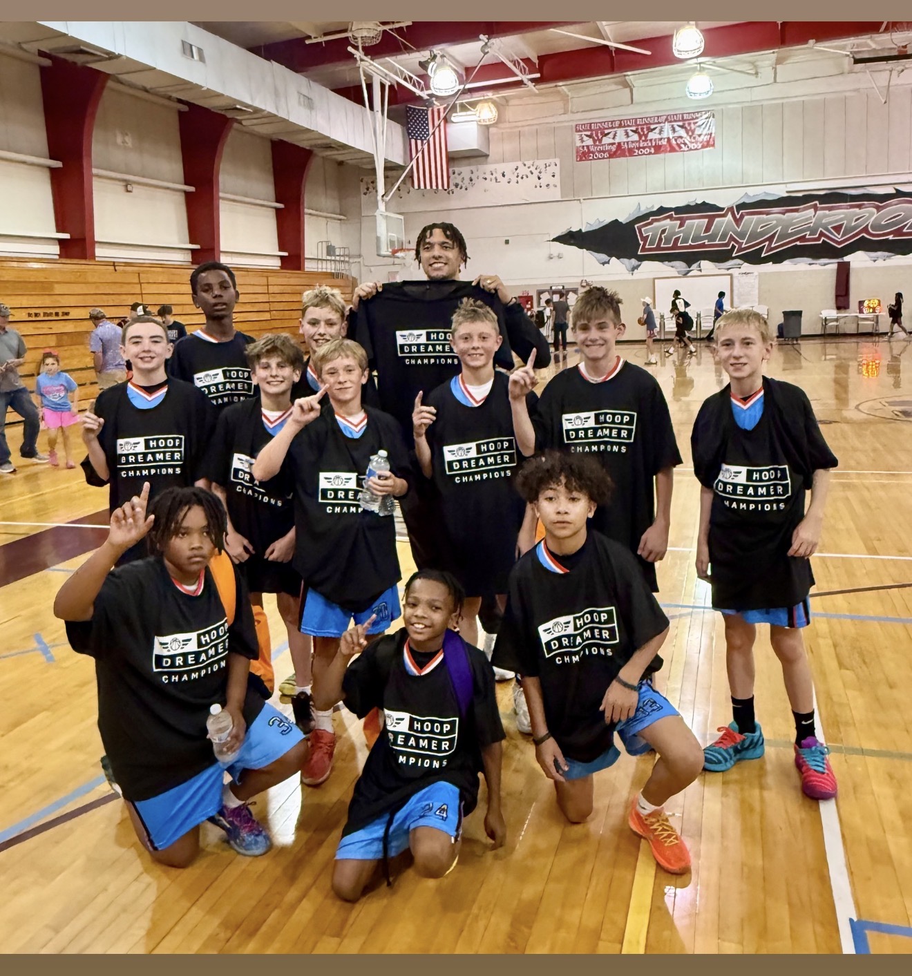 Coach Sam Baker and the BEA Suns 5th and 6th grade team celebrating their Colorado Springs Summer Slam championship